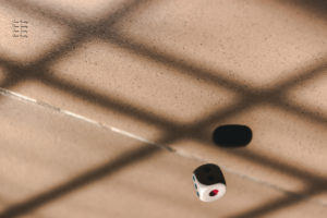 a die rolling on a concrete floor
