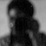 blurred image of a girl holding a camera.