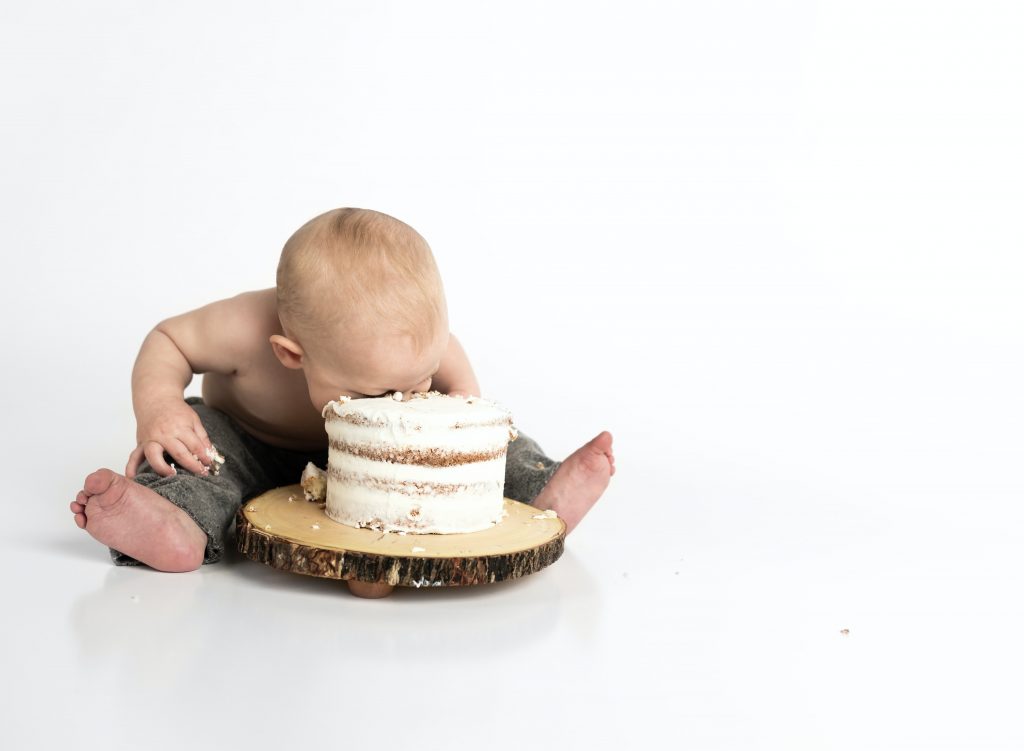 "What's in it for me?" a baby has his face in cake