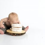 "What's in it for me?" a baby has his face in cake