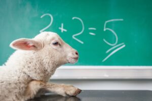 image of a goat with a blackboard background that says 2+2=5
