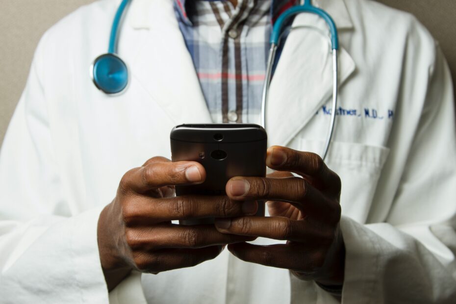 close up image of a doctor using a phone